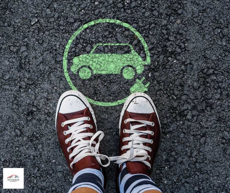 le nuove norme Euro 6e - piedi sull'asfalto con converse rosse e bianche con auto elettrica verde