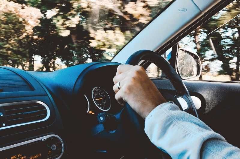 guidatore in auto, le mani sul volante. Sistemi di controllo velocità nuova direttiva Europea